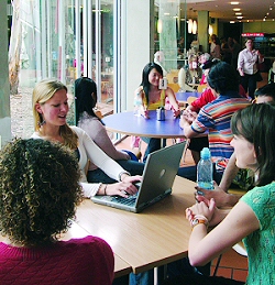 Students relaxing in a restaurant on UC Concourse