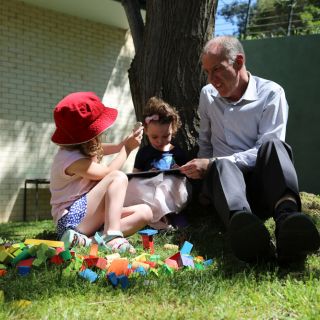 Professor Tom Lowrie and two preschoolers explore a tablet-based app and play with blocks