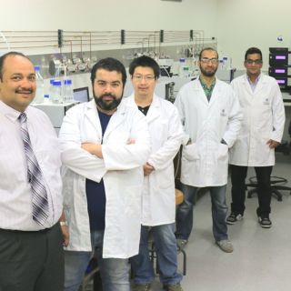 Dr Ashraf Ghanem and his research team stand in their laboratory