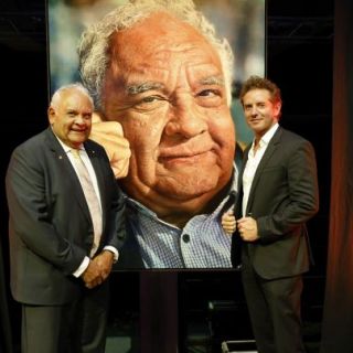 Photo of the portrait with the artist and the subject.