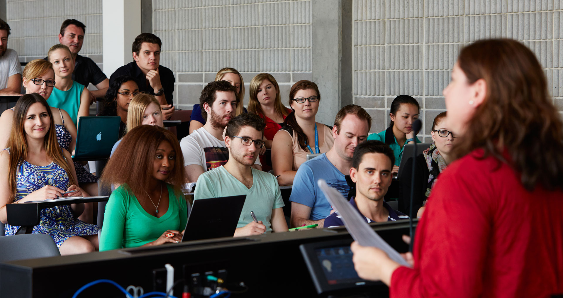 students sit in tiered seating for a lecture