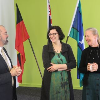 Peter Radoll congratulates Valerie Caron and Fiona Dyer on their grant for the waterhole project