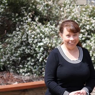 Dr Janine Deakin poses for a profile photo in a garden at the University of Canberra