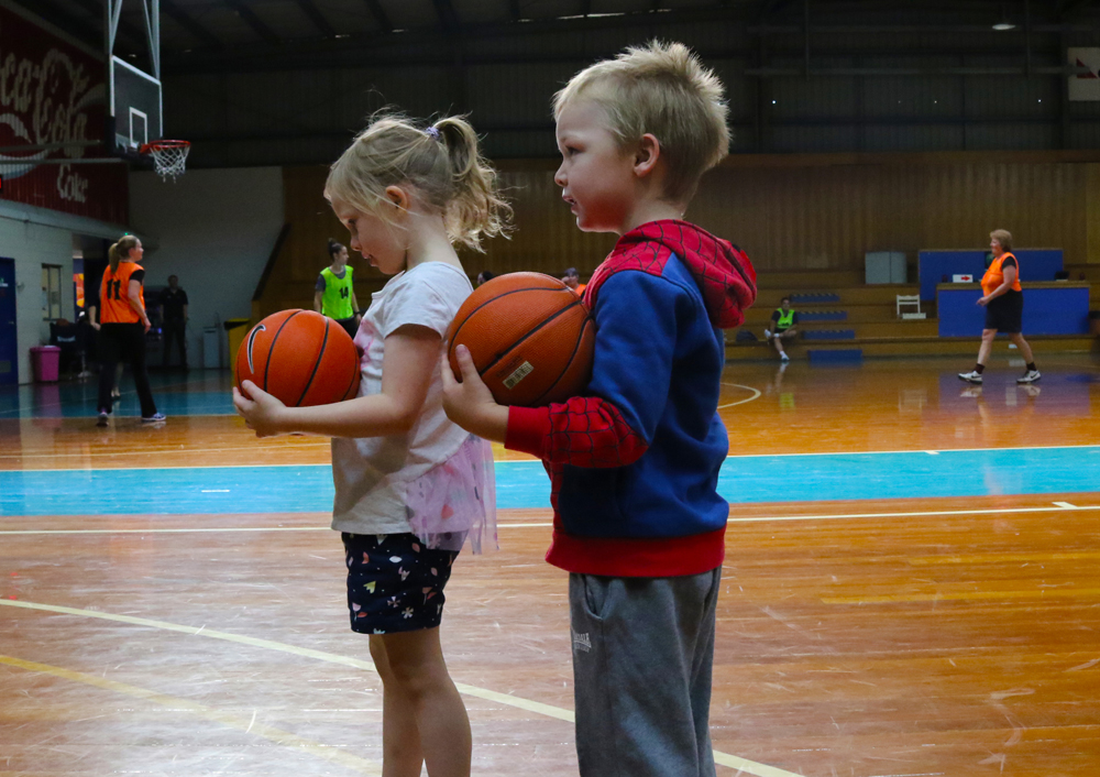 Image of young children playing basketball