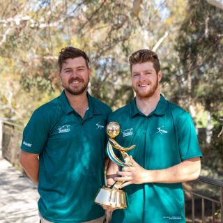 Matt Harrow and Nathan Lynch with the U23 Softball World Cup trophy