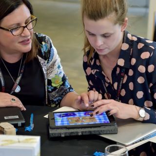Early childhood educators using a tablet device and STEM focused app