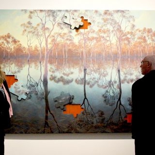 Dementia and Art Program participants examine a painting at the National Gallery of Australia