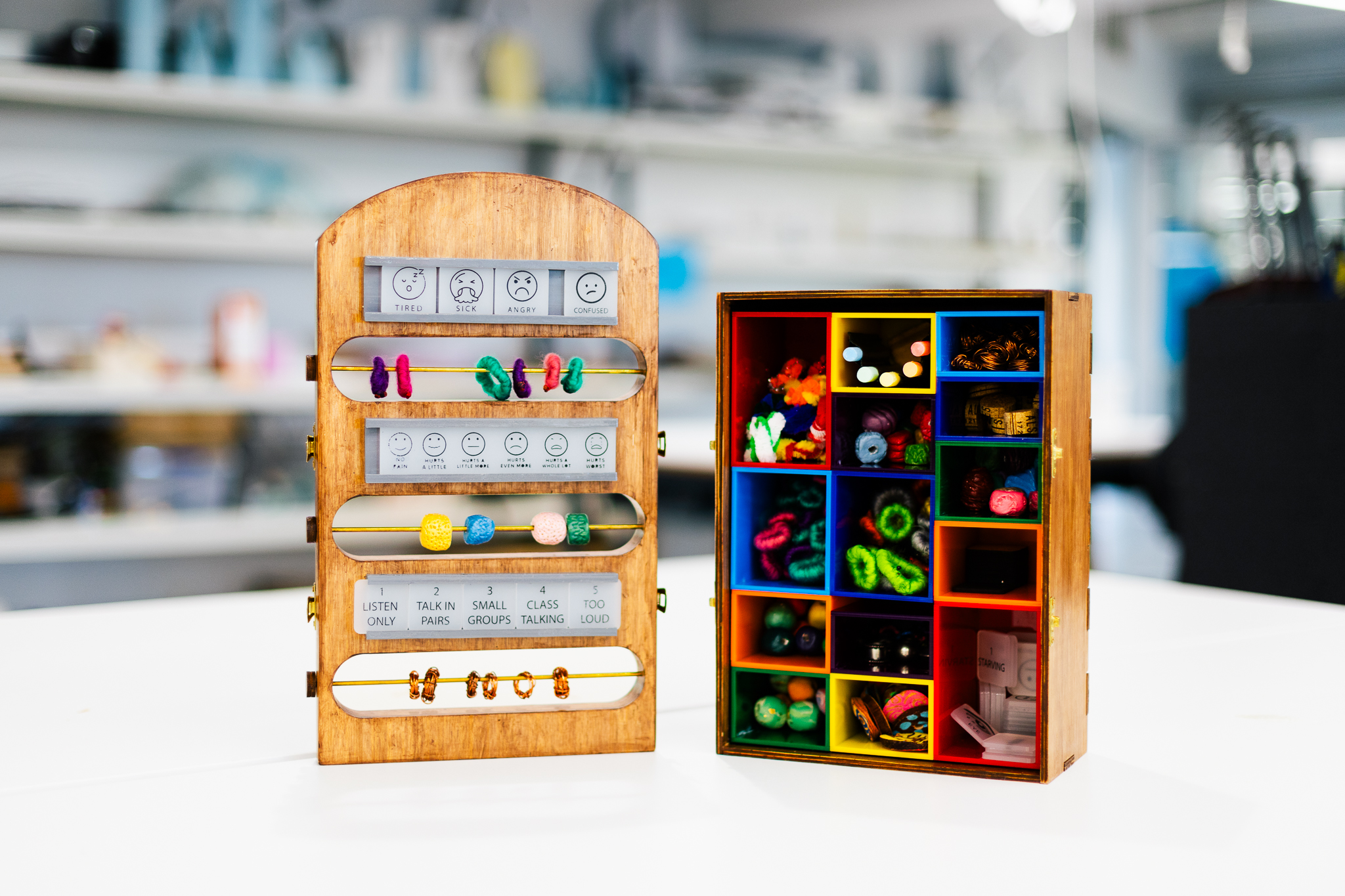 A wooden box with colourful containers