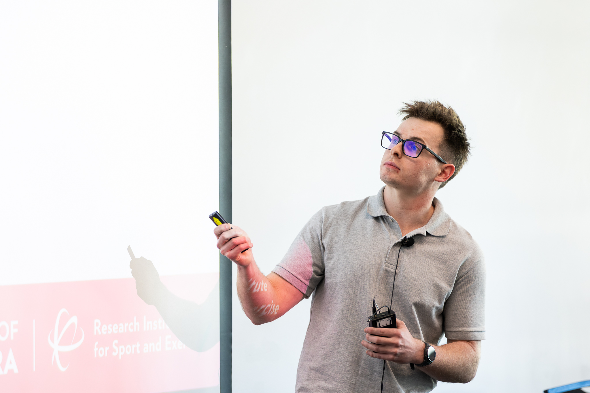 man presenting at front of room