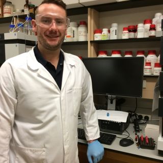 Johncarlo Maddalena standing in his lab