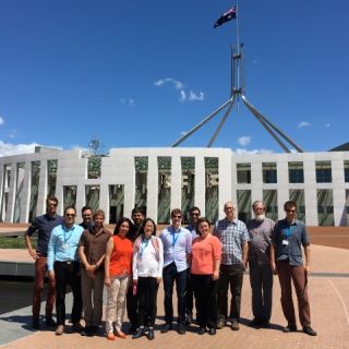 Attendees and organisers of the forum pose outside Parliament House in Canberra