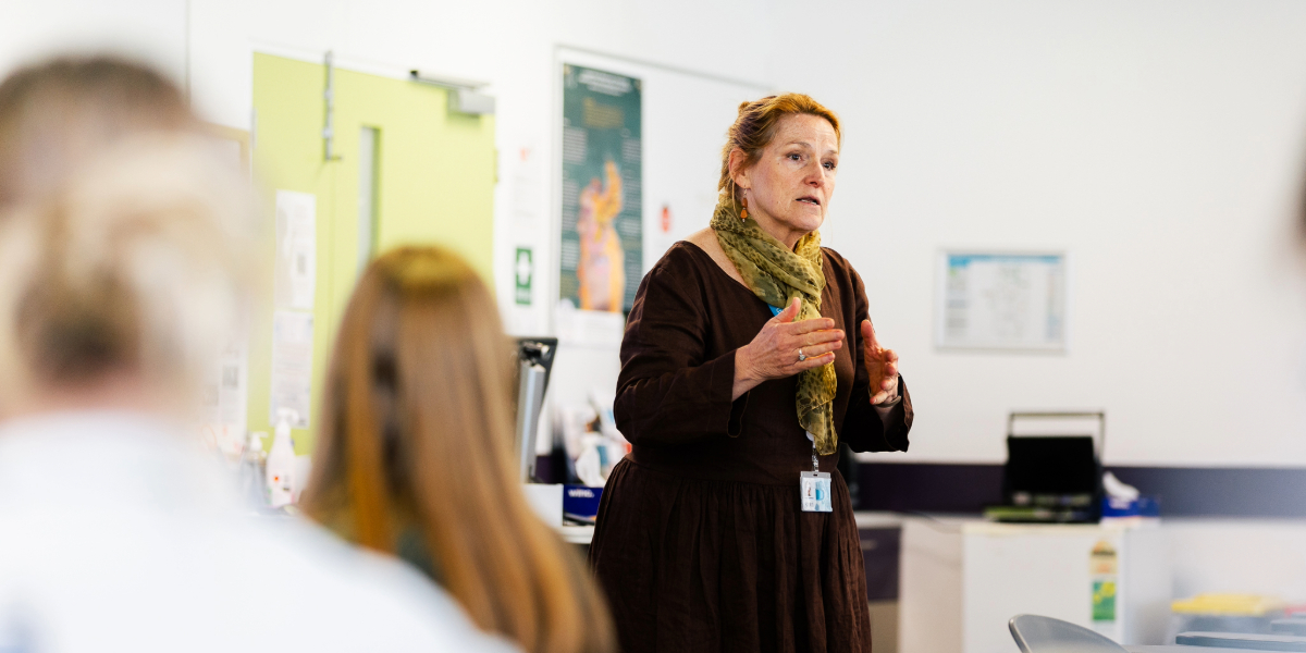 woman teaching at front of class