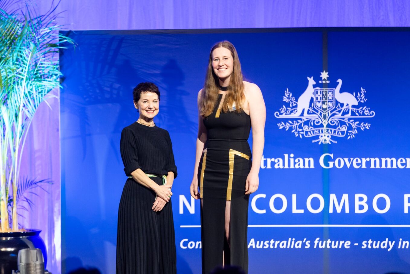 Award recipients pose for a photo on a stage
