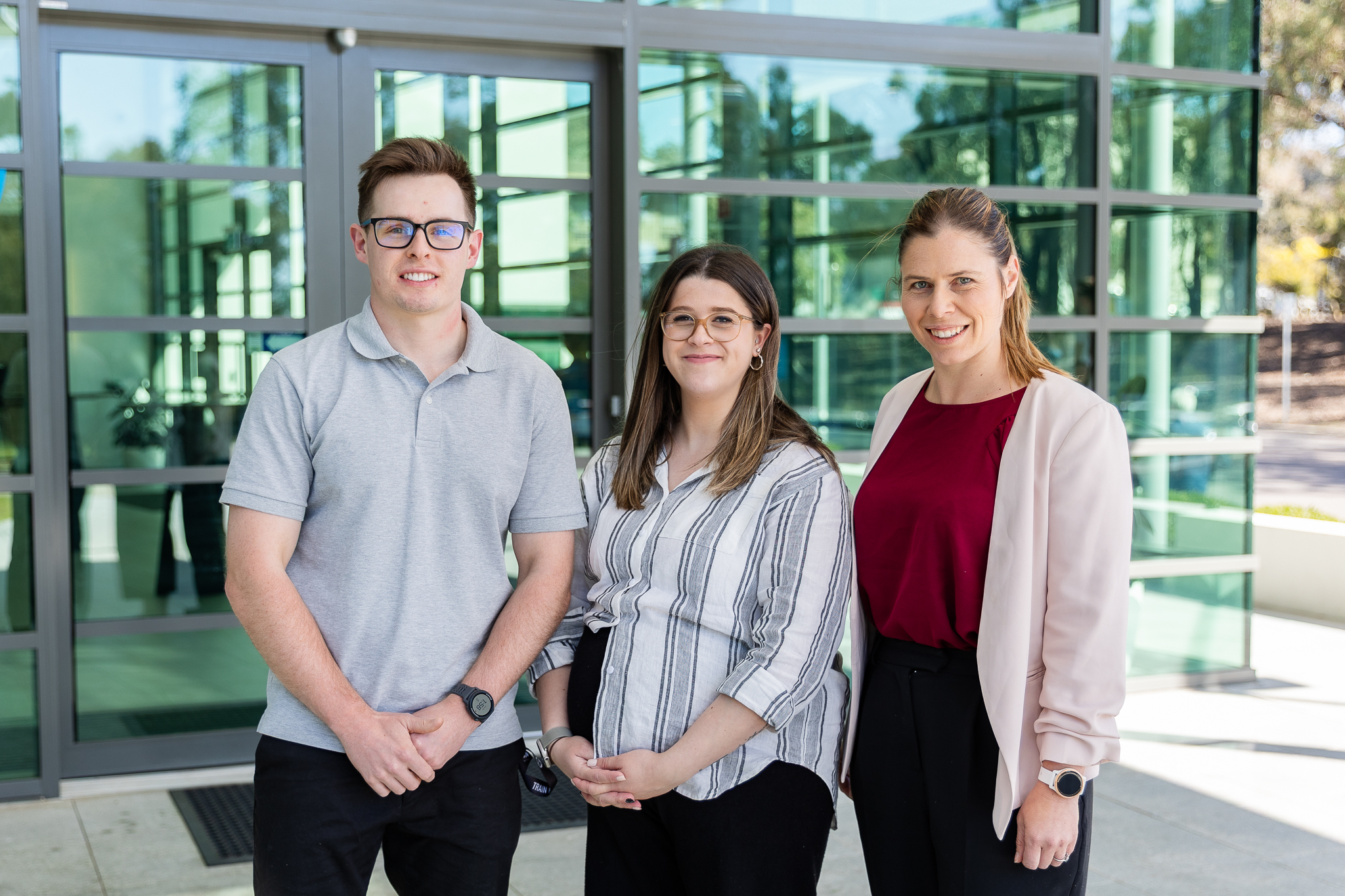 three people stand together