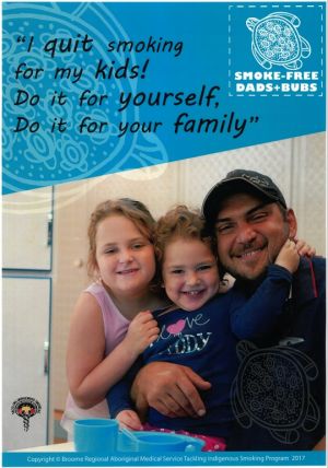 A poster of a dad with two daughters which says I quit smoking for my kids! Do it for yourself, do it for your family