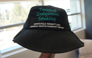 Black bucket hat which says Tackling Indigenous Smoking; Winnunga Nimmityjah Aboriginal Health and Community Services