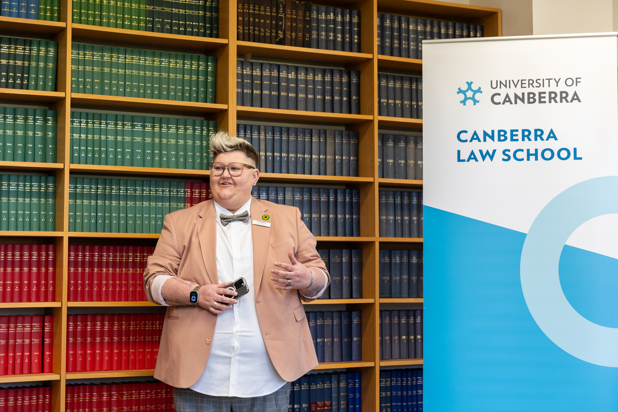 Woman standing in front of law books