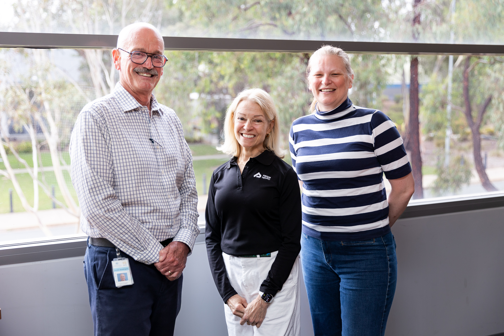 A professor, CEO and PhD student standing together