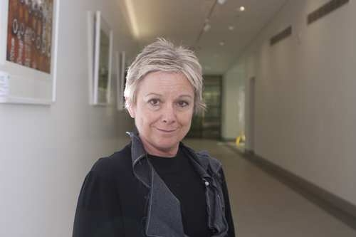 Professor Jen Webb stands in the hallway of Building 20 at University of Canberra
