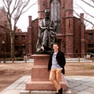 Ben Hamer rests next to the statue of Theodore Dwight Woolsey at Yale University