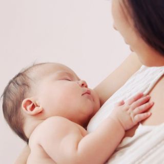 A mother nursing a small baby
