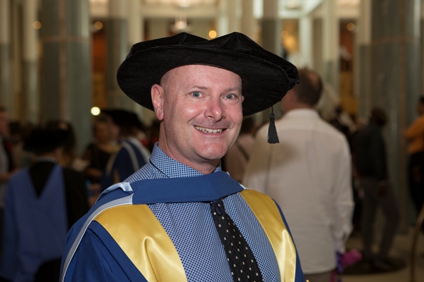 Dr Rob Stanton at his graduation ceremony decked out in his gown and bonnet