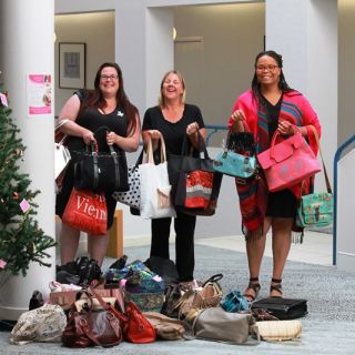 UC staff Naomi Dale, Linda Kujala and Cindy Mitchell carry handbags for the Share the Dignity Collection