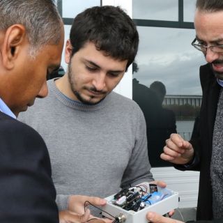 Dr Kumudu Munasinghe and research assistants Adrian Garrido Sanchis and Lorenzo Bertolelli inspect the IoT unit which will be used to eavesdrop on local frogs. Photo: Kim Pham