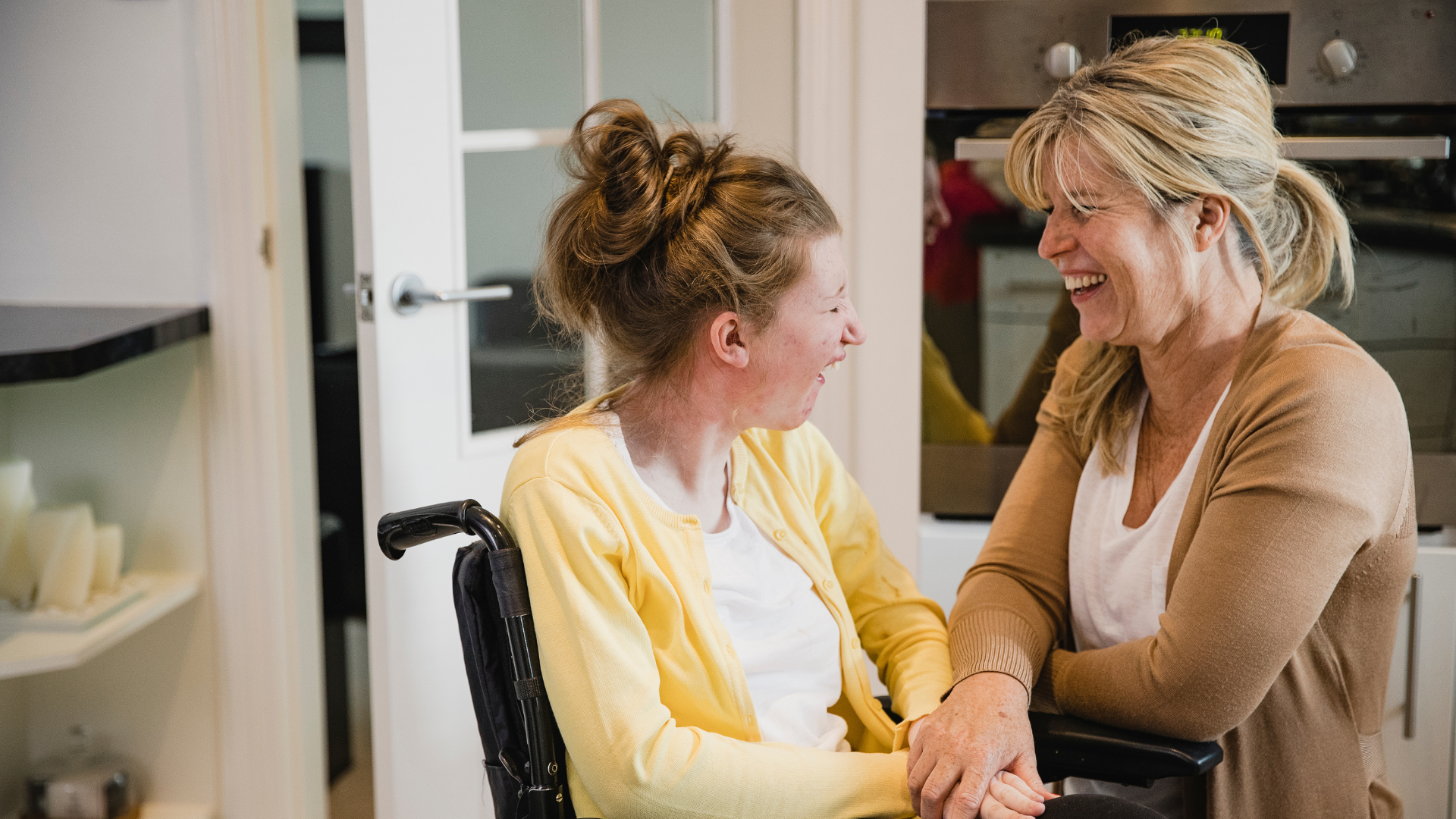 Two women sitting together laughing 