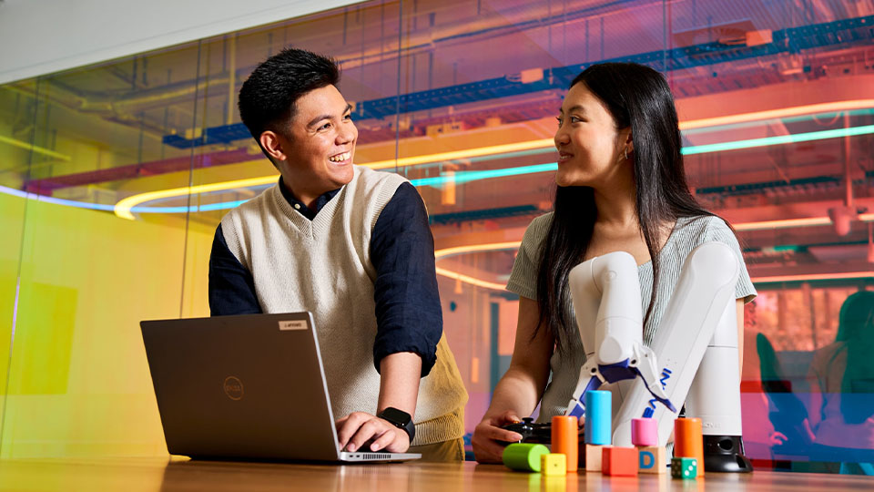 two students discussing computer