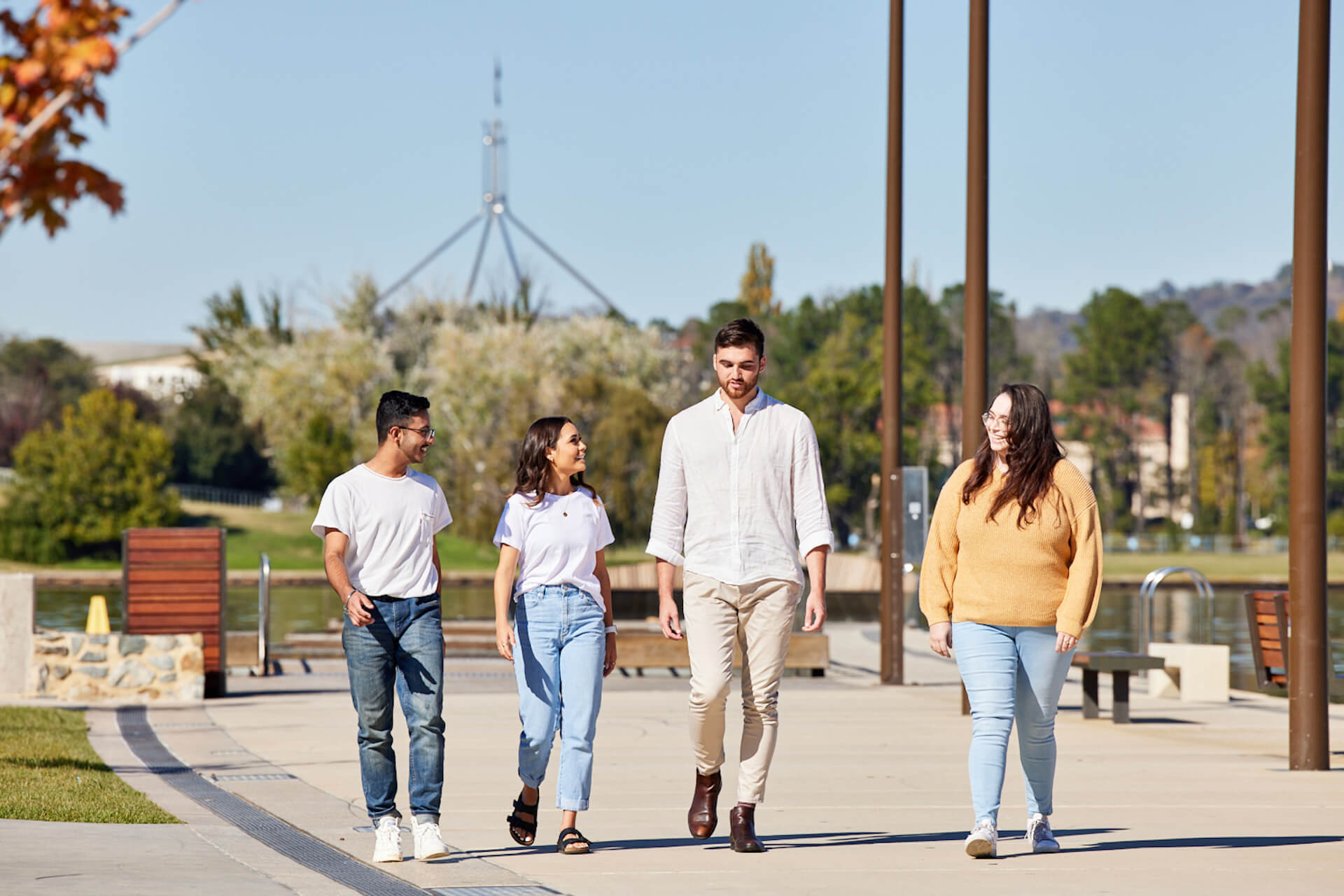 Event and tourism management students walking with the Parliament House in the background